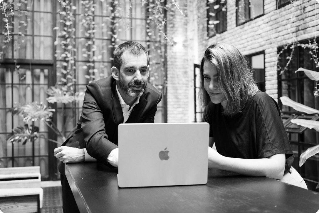 Ben with a client at a laptop